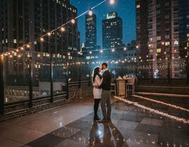 Couple kissing in the rain on a rooftop