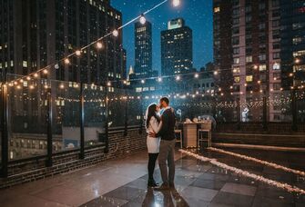 Couple kissing in the rain on a rooftop