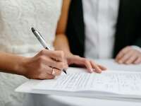 Signing papers on wedding day