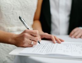 Signing papers on wedding day