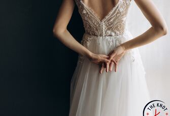 Bride clasping hands behind her back