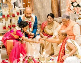 Couple with in laws during traditional ceremony