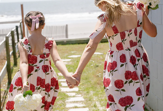 Mom and daughter wearing matching pink striped hydrangea mommy and me dresses from Pink Chicken