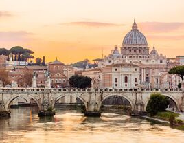 Rome skyline at sunset with Tiber river and St. Peter's Basilica, Italy 