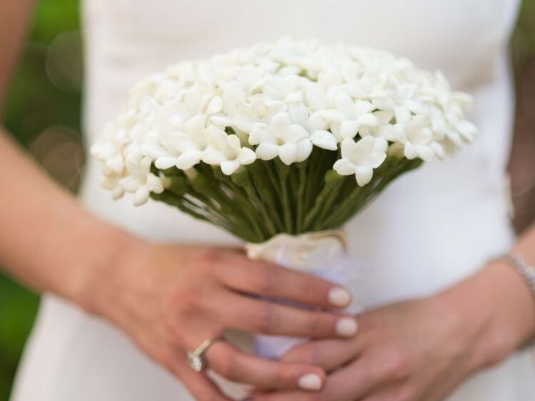 A bride holding stephanotis wedding bouquet