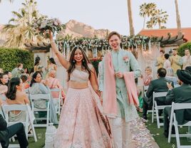 Couple celebrating while walking down the aisle