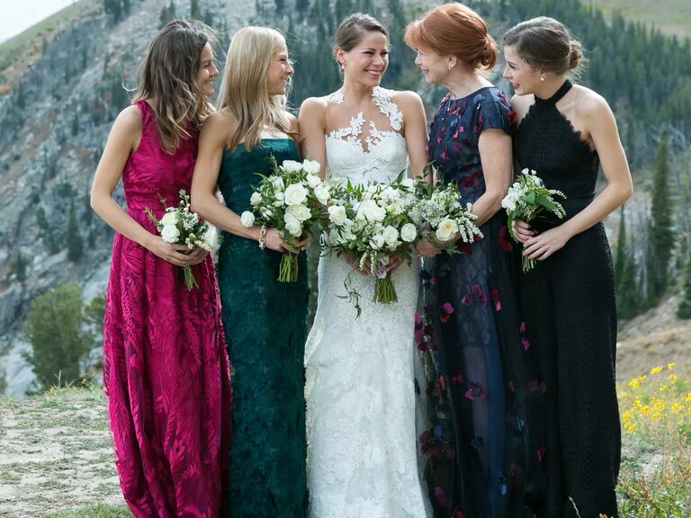 real wedding photo of mismatched jewel-tone bridesmaid dresses