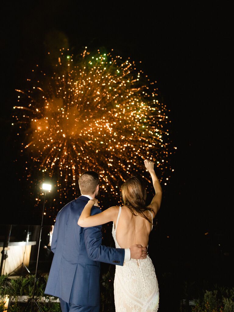 bride and groom outside watching fireworks