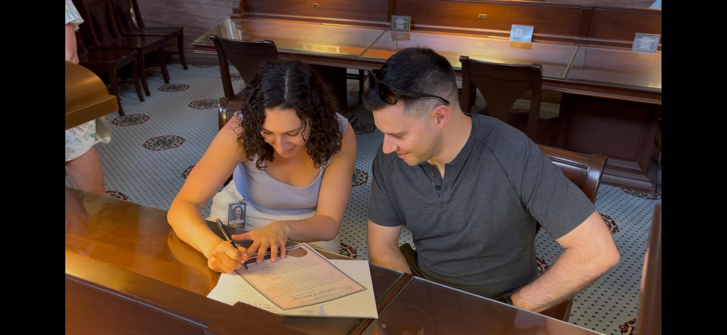 We got married! Signing documents at the Library of Congress.