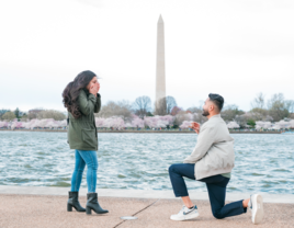 Man proposing to woman in front of water and washington monument in Washington DC