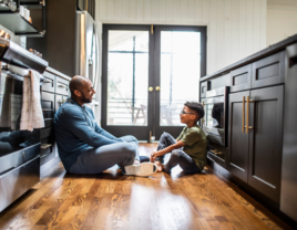 Dad and son talking on the kitchen floor