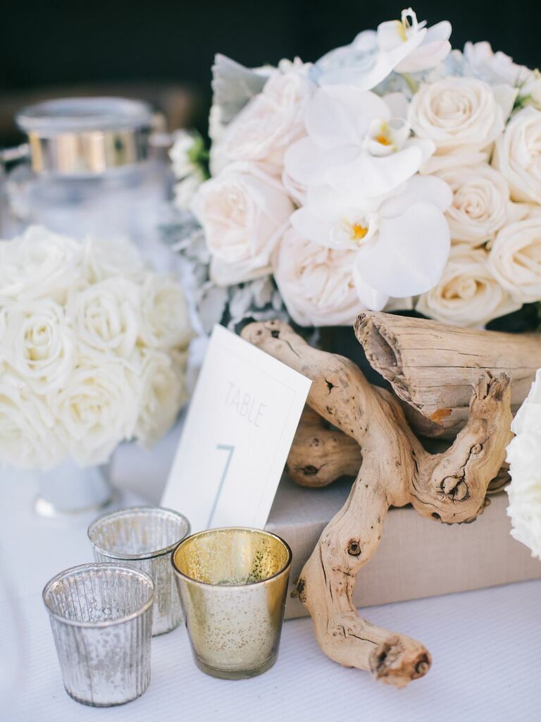unique beach wedding centerpiece idea with driftwood, white roses and orchids