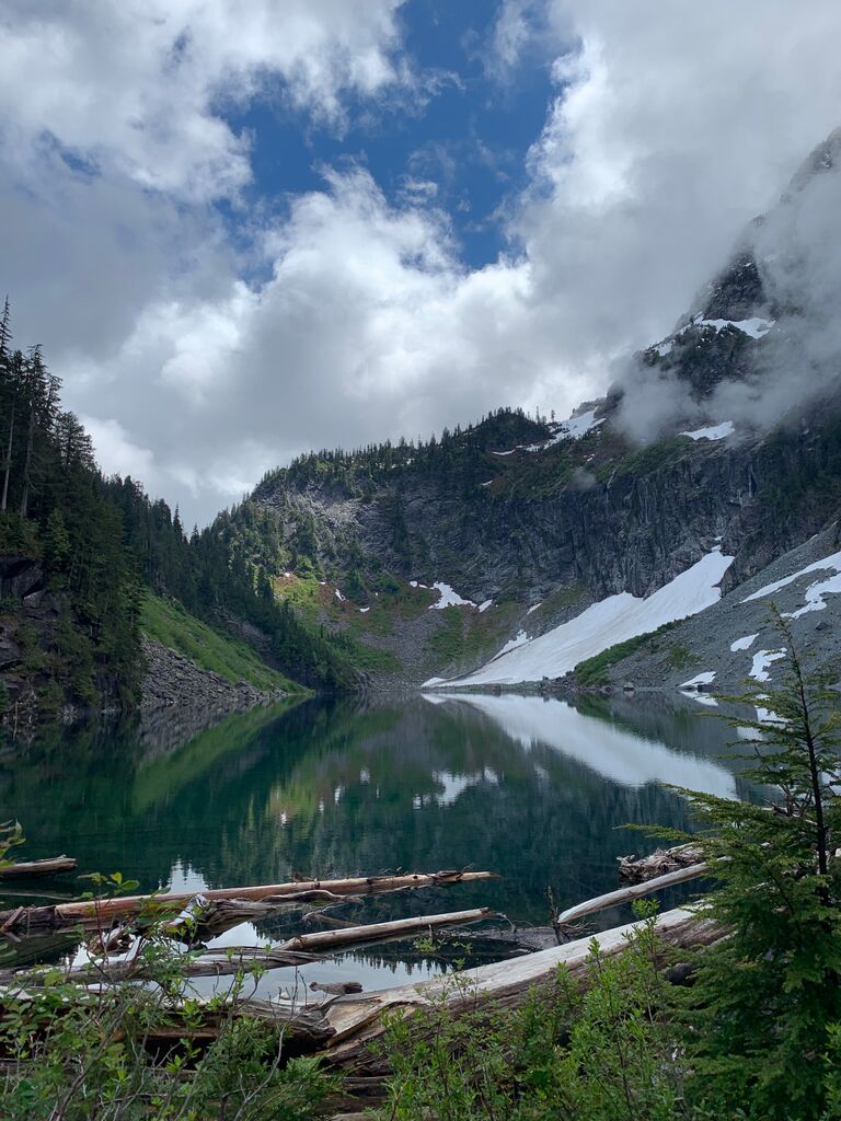The First Date: A hike to Lake Serene and Bridal Veil Falls, located in Index, Washington. 

After talking on the phone nearly every night for about two weeks, Logan invited Candace to go on a hike she mentioned always wanting to do as their first date. 

Logan packed a picnic lunch for them to enjoy once they reached the top. Unfortunately he didn’t think through the containers used for the picnic… Packing the lunch into glass containers was a bit heavy for a 7+ mile hike with a pretty significant elevation gain (never did that again).

They talked non-stop the whole way up, and once they reached the top they found a good spot to sit and enjoy the view. They even made friends with a little chipmunk who thought the picnic was for him. 

The date was filled with so much laughter and smiles that their faces hurt by the time they said their goodbyes. To this day, they still laugh at the inside jokes that came from that date.

They even started a new tradition of getting trail mix on the way home after every hike they take. It is worth mentioning that trail mix really just means peanut M&M's.

Some people thought going on a hike, located more than an hour from home, for a first date was a risky venture. "What if you get half way up the trail and can't stand each other? That would be a long and awkward drive home." Thankfully that was not the case for this couple. Their first date was absolutely perfect.

This hike was the starting point of the amazing adventure to come, and Lake Serene has held a significant and special place in their hearts. 