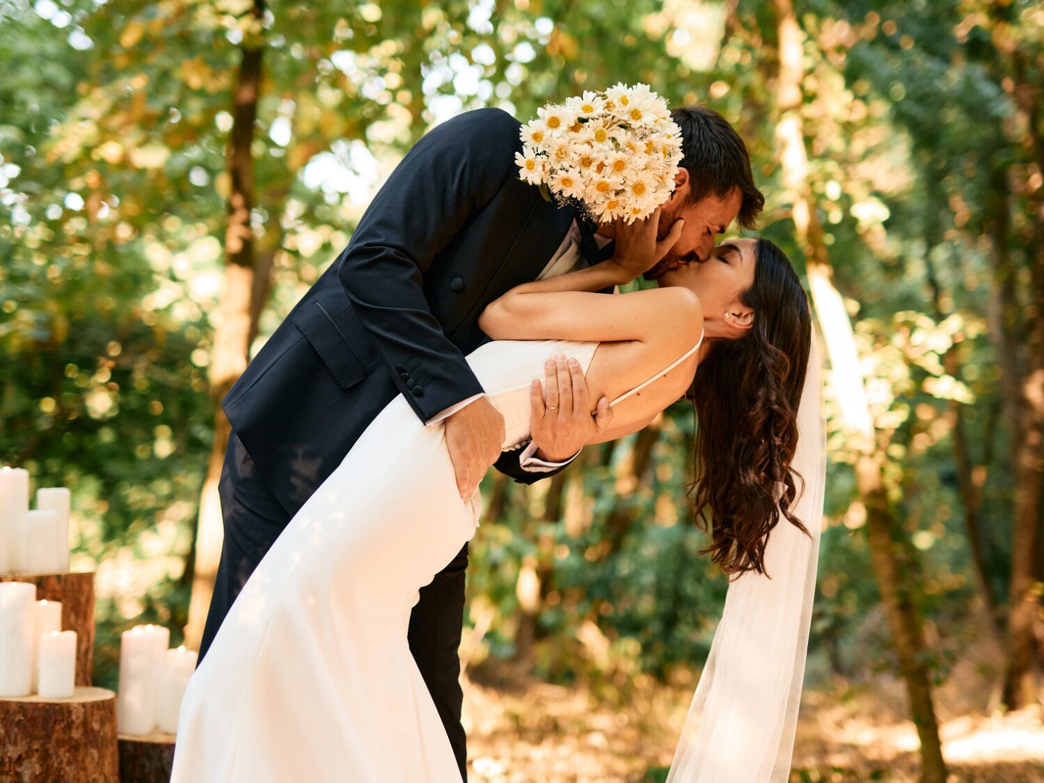Couple hugging and holding white wedding bouquet
