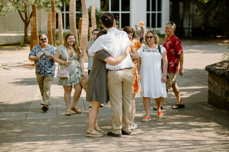 The Osborns and Hallers pop out from behind a corner to congratulate the newly engaged pair. 