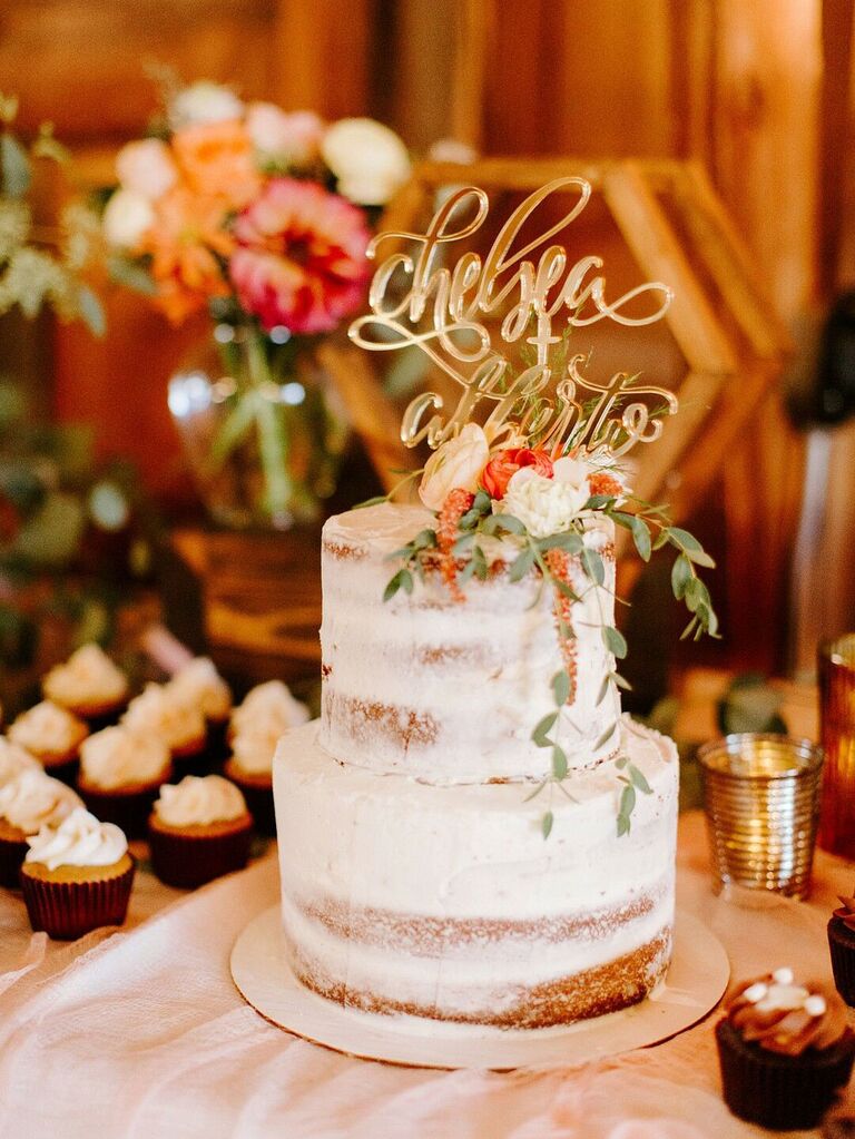Two-tier semi-naked rustic wedding cake with glam gold cake topper and fresh flowers