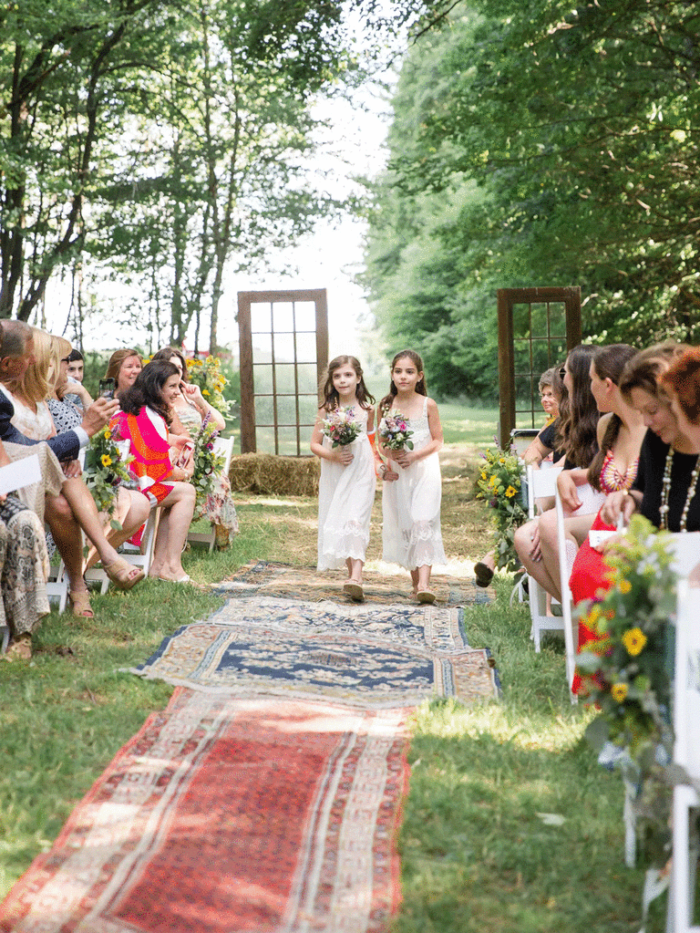 Colorful bohemian rugs at DIY wedding. 