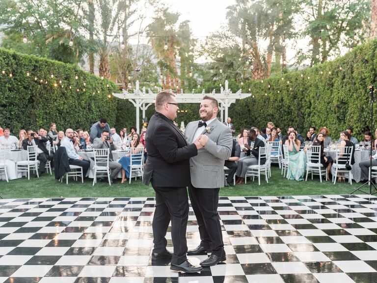 Grooms during first dance song at outdoor wedding reception