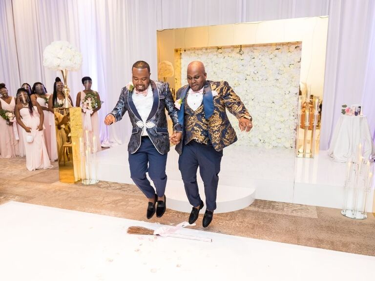 african-american grooms jumping the broom at ballroom wedding
