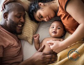 parents snuggling with baby