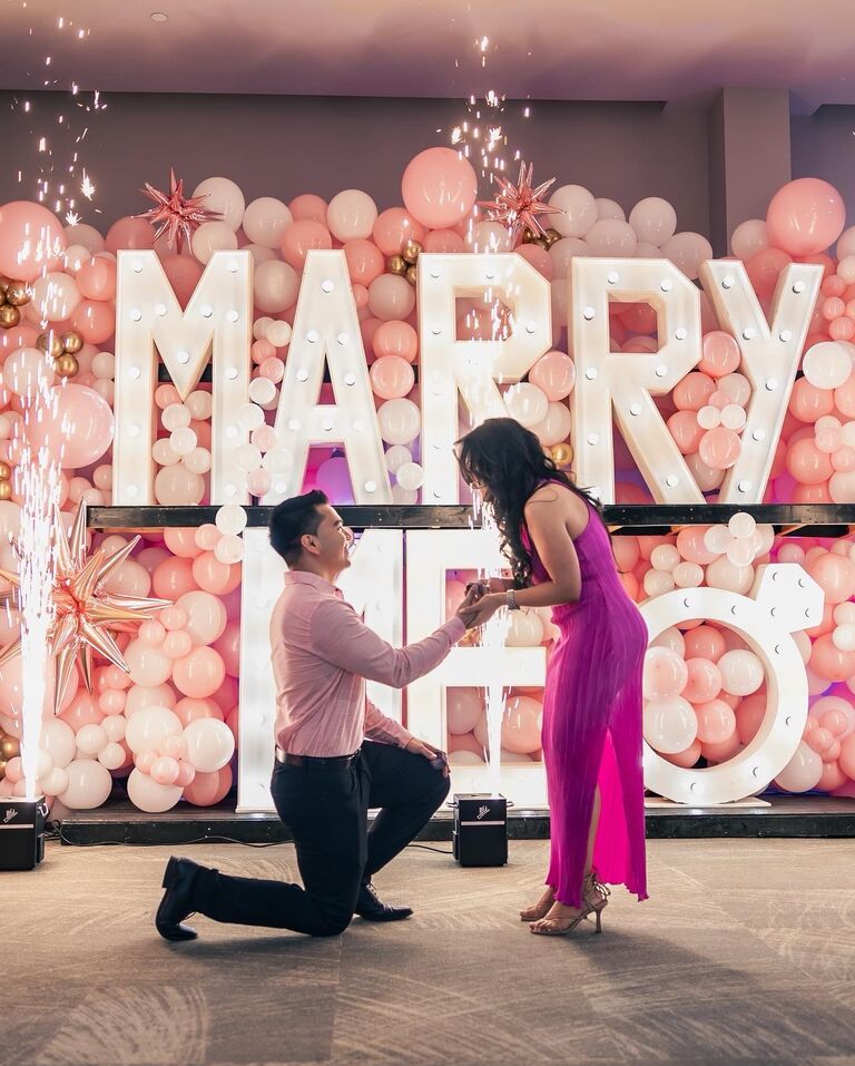 WE GET ENGAGED!!! - 
After seven years of being together, on Friday, June 30, 2023, Coco proposed to me in our hometown in Eagle Pass @8pm. The entire night was planned over a year in advance. The incredible backdrop balloon arrangement was made with over 1,600 balloons. Coco's mom and sister had such an amazing vision with the Marry Me letters to top it off. Our close friend Chavarria was a part of the production and Eric Ramos Photography captured the entire night. Close family and friends gathered with us that night to share in one of the most amazing nights of our lives. Next stop, WEDDING DAY!