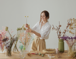 Woman making flower bouquet at bridal shower flower bar