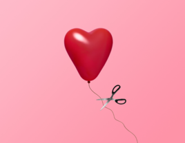 Heart balloon being cut with scissors