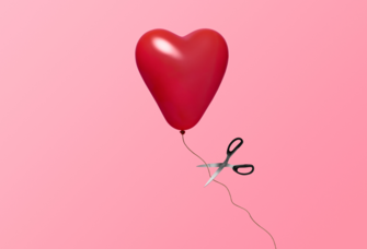 Heart balloon being cut with scissors