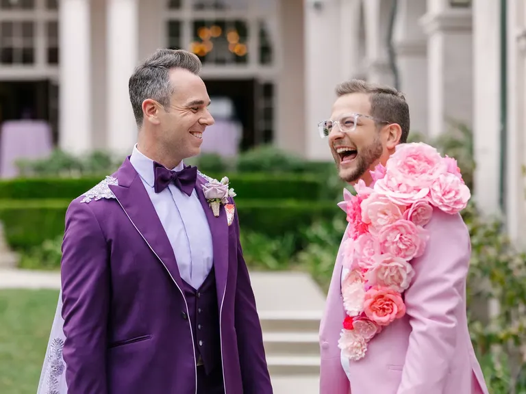 Groom in Purple Tuxedo With Cape, Boutonniere and Groom in Pink Tux With Cascading Floral Lapel