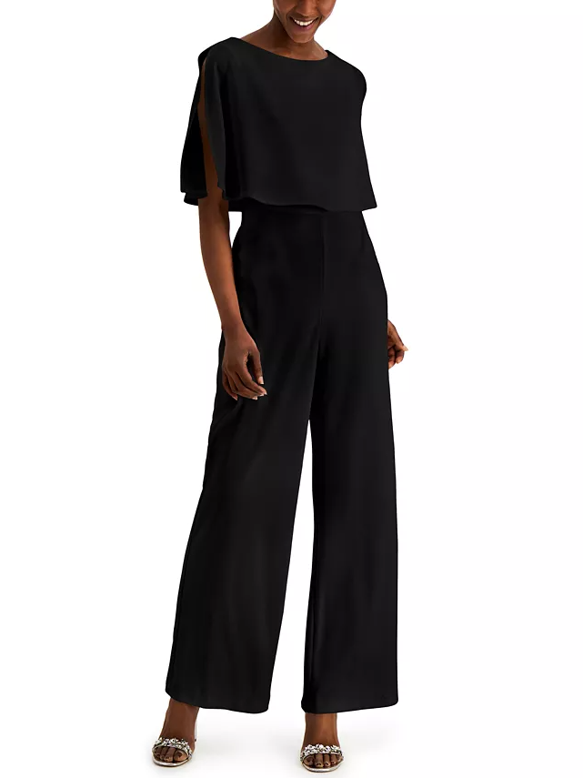 Model wearing a black jumpsuit with short split sleeves