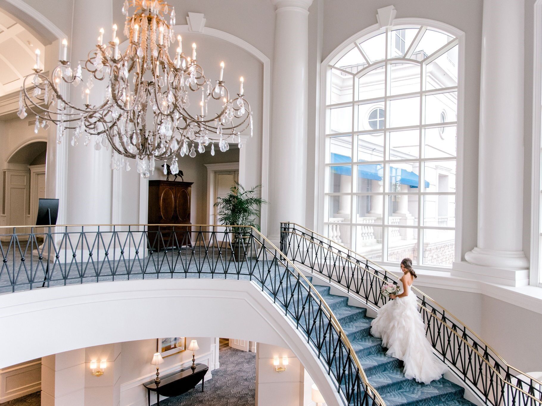 Bride walking up the steps of the grand staircase