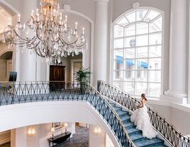 Bride walking up the steps of the grand staircase