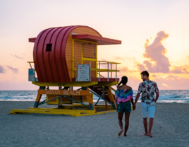 Couple walking on Miami Beach at sunset