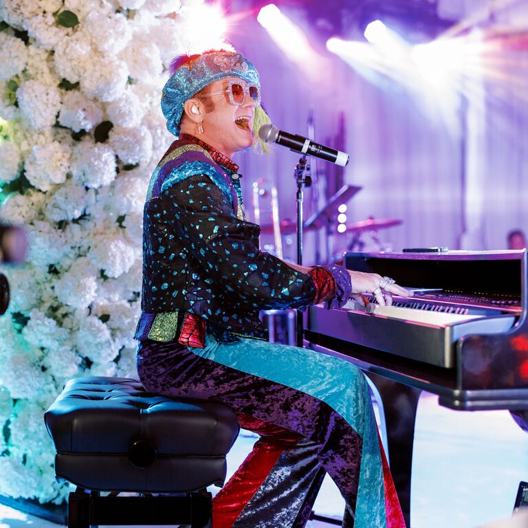 Sir Elton John signing at wedding reception