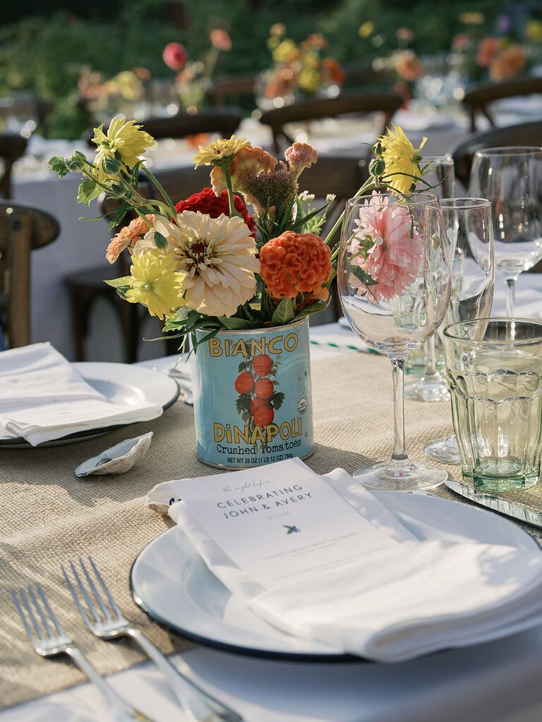 Flowers in tomato can at wedding reception