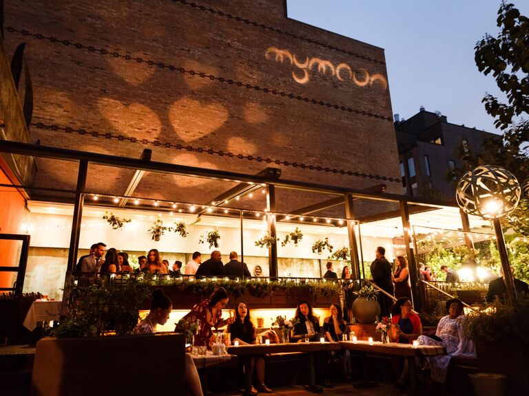 Guests dine on a sleek patio at a trendy restaurant. 