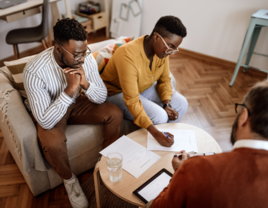 Couple signing documents with lawyer