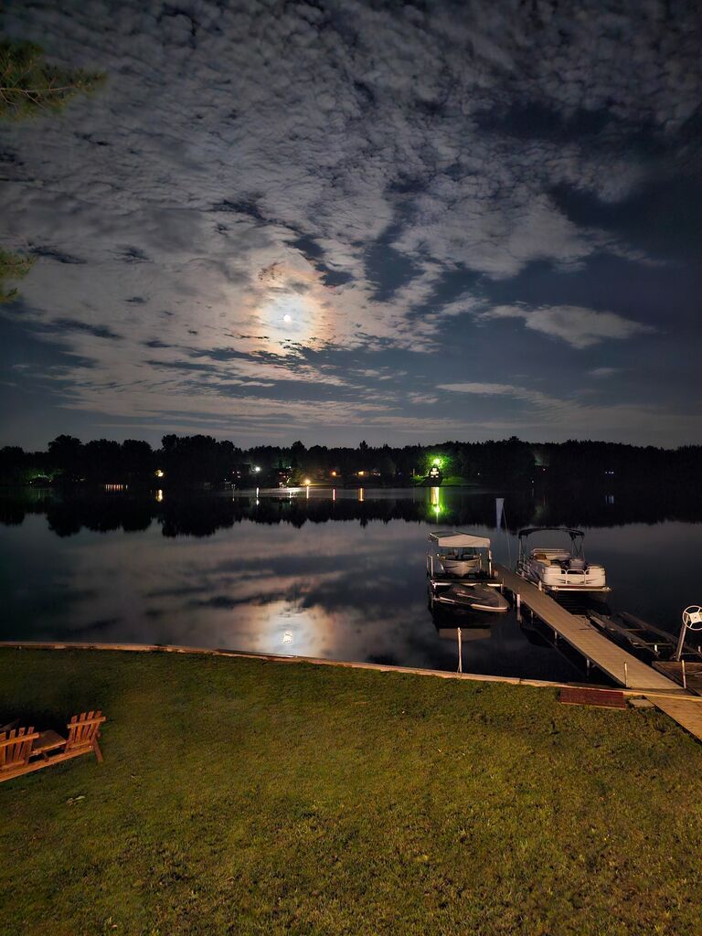 We finally arrived at the lake and I am now super nervous. We grab our stuff to head out to the dock for Shaun (my youngest brother) to pick us up on the boat. And at this point, all my planning began to fail… First, I needed it to be completely dark so that the lights I had set up the previous weekend (shout out to my Pops for helping me with that!) would show up clearly because they weren’t super bright. With my luck, it happened to be a full, glowing moon that night without a cloud in the sky! To me it seemed like it was basically daylight and my displays weren’t going to work! Next, Megan decided to put on an old coat to go out on the boat… covering her beautiful dress for these surprise photos. I tried to hurry her to the dock and suggested we come back for our stuff in the morning since it was already “so late and I am tired” but her cute little stubbornness then decided to carry MORE stuff for me instead. Watching my plan fall apart so fast, I just pushed on and we carried EVERYTHING down to the dock. The lake was silent and calm as we waited for Shaun to arrive. After a couple failed phone calls and no texts getting through, I realize, I have no service to message Shaun that we have arrived. I now have no idea how we are going to get to the house! Starting to freak out internally, trying to keep calm and relaxed in front of Megan who I hoped still had no idea, we heard a faint motor sound echoing across the water from the other side of the lake. THANKFULLY, Shaun was paying attention to my location through Snapchat and tried timing the pickup perfectly to our arrival. What had felt like 30 minutes of shear panic, was actually only about 5 minutes of watching Shaun drive across the lake and pick us up. THANK YOU AGAIN SHAUN! 