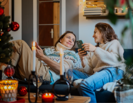 two girlfriends on couch at Christmas time