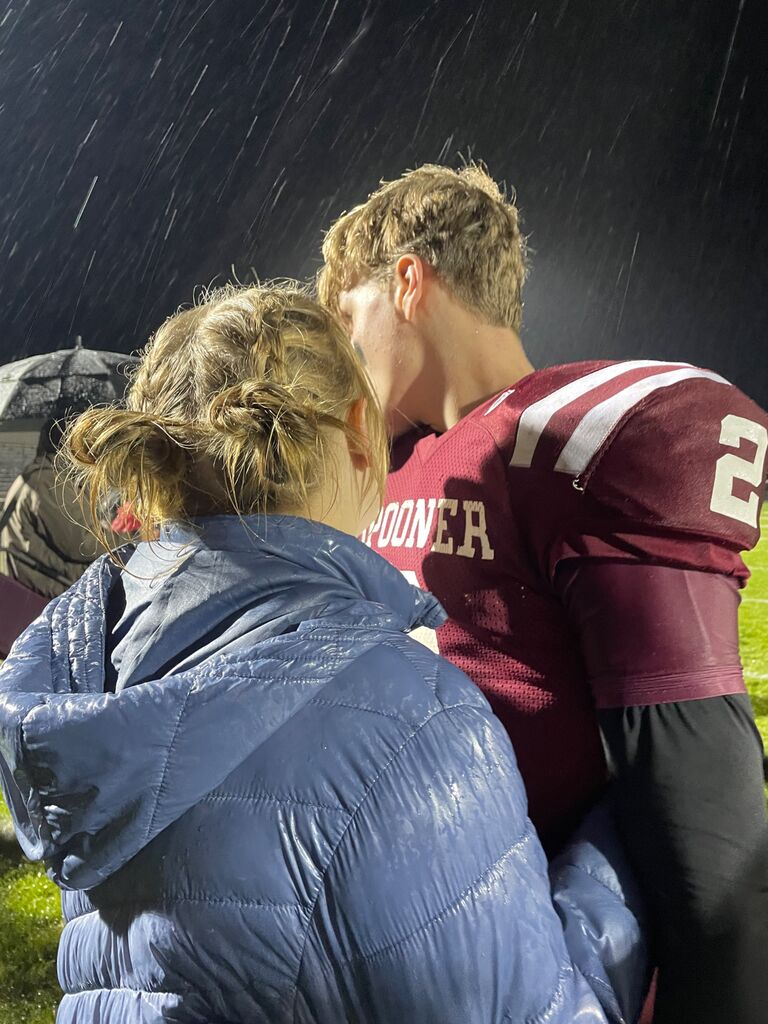 She supported him at all his foot ball/base ball games, and was his number one fan!