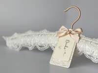 Padded white lace hanger with elegant personalized 'bride' tag