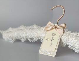 Padded white lace hanger with elegant personalized 'bride' tag