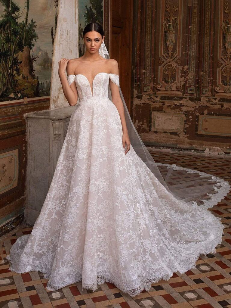 camellia bridal shop white off the shoulder wedding dress with sweetheart neckline with deep v allover lace and ball gown skirt