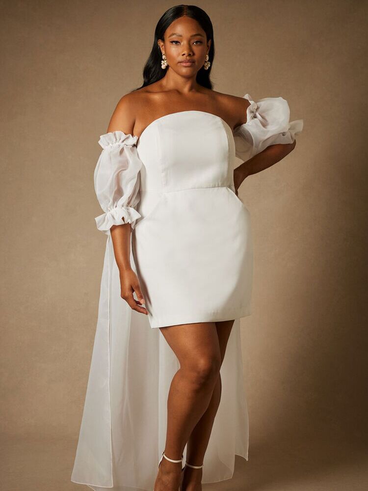 White rehearsal dinner minidress with puff sleeves and cape from Bridal by ELOQUII