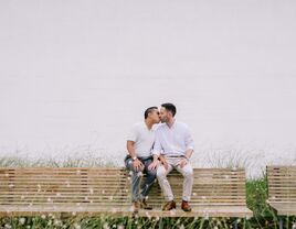 Couple share a sweet kiss at their engagement photo shoot. 