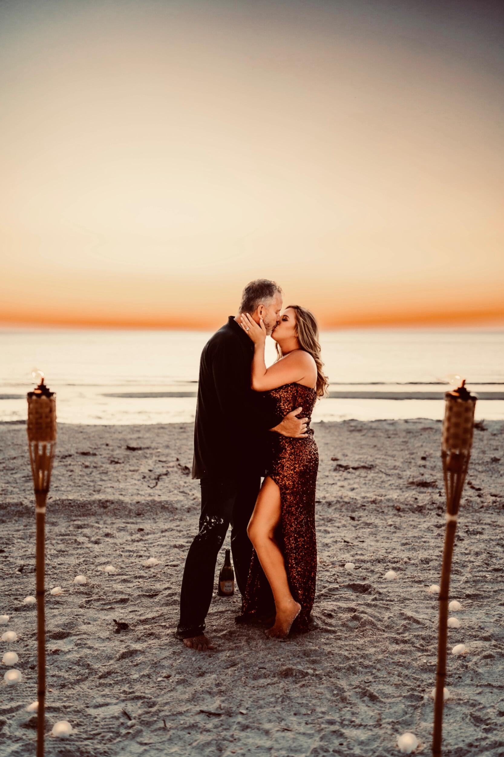 Lindsay had set up a professional photographer to fly down from Atlanta and take family photos along with some photos of her and Don alone. Day one of the photo shoot would just be the two of them. Don knew the plan so he reached out to the photographer and told her his plan of asking her to marry him. She was all in! Don then got his son Connor to carry out the next part of the surprise. He drew up a plan of candles, champagne and tiki torches on the beach and he did this flawlessly. As they walked up the beach they came upon this romantic setting of 100 candles shaped like a heart and a walkway leading up to that heart. Don walked her down the path and into the heart and into each other's hearts forever.