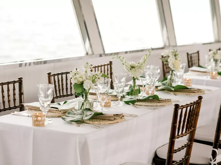 Wedding reception tables with boho decor and white flowers on The Carolina Girl Yacht