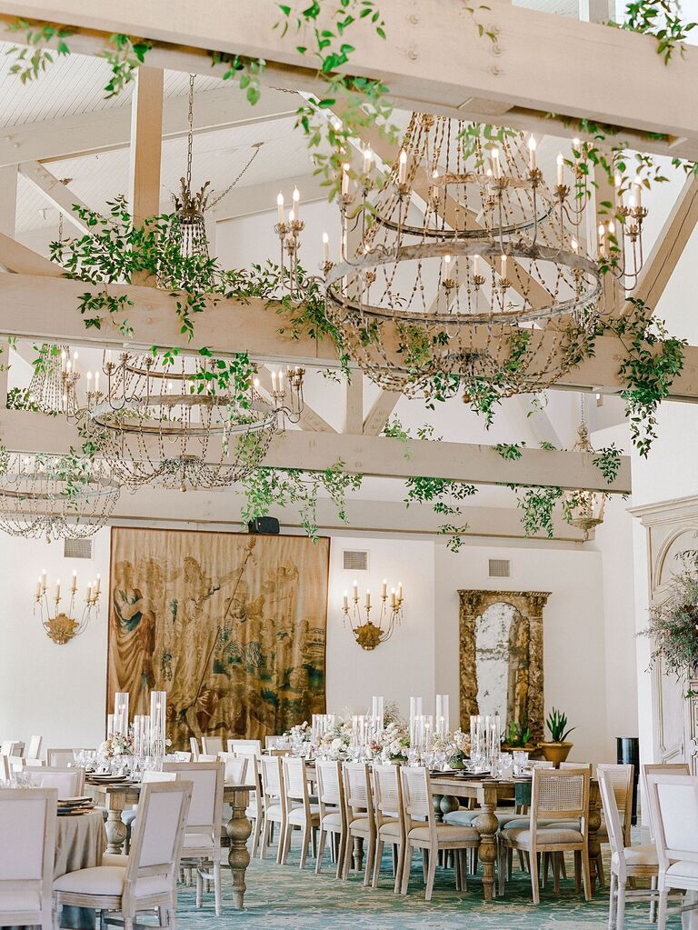 Boho chandelier and greenery wedding reception space