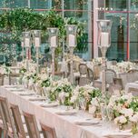 spring wedding tablescape with tall silver candlesticks and low centerpieces with white flowers
