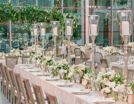 spring wedding tablescape with tall silver candlesticks and low centerpieces with white flowers